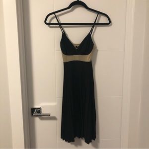 Sexy V-neck black and gold dress with pleated skirt